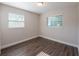 This bedroom boasts wood-look floors, neutral walls, and natural light from the windows at 4226 Kelly Miller Ct, Orlando, FL 32811
