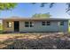 Charming single-story home featuring a neutral color, dark front door, and large windows at 4226 Kelly Miller Ct, Orlando, FL 32811