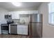Kitchen featuring granite countertops, stainless steel appliances, white cabinets and luxury vinyl flooring at 4226 Kelly Miller Ct, Orlando, FL 32811