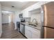 Kitchen featuring granite countertops, stainless steel appliances, white cabinets and luxury vinyl flooring at 4226 Kelly Miller Ct, Orlando, FL 32811