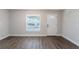 Comfortable living room featuring wood-look floors and a large window at 4226 Kelly Miller Ct, Orlando, FL 32811