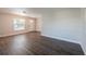 Inviting living room featuring wood-look floors, neutral paint, and a bright window at 4226 Kelly Miller Ct, Orlando, FL 32811