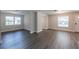 Open-concept living room boasts wood-look floors, neutral walls, and lots of sunlight at 4226 Kelly Miller Ct, Orlando, FL 32811