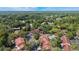 Aerial view of community featuring lush trees, townhomes, pool, and parking at 424 Club Dr, Winter Springs, FL 32708