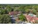 Community buildings with red tile roofs and ample parking are surrounded by lush trees at 424 Club Dr, Winter Springs, FL 32708