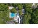 Aerial view of community pool and white modern building surrounded by lush trees and a parking lot at 424 Club Dr, Winter Springs, FL 32708