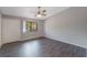Bedroom with laminate floors and a window with a view of trees and a parking lot at 424 Club Dr, Winter Springs, FL 32708