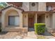 Close-up of townhome entrance with visible address, sconces, tidy shrubs, and shaded walkway at 424 Club Dr, Winter Springs, FL 32708