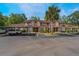 Exterior view of townhome with assigned parking and tidy shrubbery in a well-maintained community at 424 Club Dr, Winter Springs, FL 32708