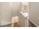 Hallway with wood floors, view into living room and door to basement stairs at 424 Club Dr, Winter Springs, FL 32708