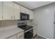 This kitchen features tile backsplash, gray countertop and white cabinets and a microwave at 424 Club Dr, Winter Springs, FL 32708