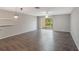Bright living room featuring modern light fixture, hardwood flooring and sliding door to backyard at 424 Club Dr, Winter Springs, FL 32708