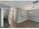 Spacious living room showcasing hardwood floors, grey walls, modern lighting, and hallway access at 424 Club Dr, Winter Springs, FL 32708