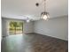 Well-lit living room with large glass slider leading to backyard and modern lighting at 424 Club Dr, Winter Springs, FL 32708