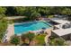 Community pool featuring a volleyball court, picnic tables, and lots of lounge chairs to enjoy at 424 Club Dr, Winter Springs, FL 32708