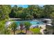 A sprawling pool area offers a volleyball court, seating areas, and lush green surroundings at 424 Club Dr, Winter Springs, FL 32708