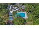 Aerial view of a modern community center with sparkling pool, lush greenery, and ample parking at 424 Club Dr, Winter Springs, FL 32708