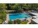 Beautiful community pool with chairs, umbrellas and a volleyball court surrounded by lush trees at 424 Club Dr, Winter Springs, FL 32708
