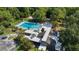 A high-angle aerial view of a pool surrounded by lush trees and a modern amenity center at 424 Club Dr, Winter Springs, FL 32708