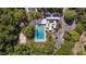 Pool overhead with lounge chairs, a volleyball court, lush greenery and a modern amenity center at 424 Club Dr, Winter Springs, FL 32708
