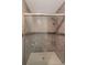 Modern shower featuring stylish tile work, a glass door, and shower caddy at 424 Club Dr, Winter Springs, FL 32708