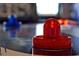 Close-up of an air hockey puck on a table with red and blue accents in a game room at 4441 Ganesha Loop, Kissimmee, FL 34746