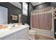 Modern bathroom featuring a combination tub and shower with dark walls, contrasted by a white vanity at 4441 Ganesha Loop, Kissimmee, FL 34746