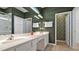 Bathroom featuring a double vanity with white cabinets, decorative towels, and an adjacent door to the shower at 4441 Ganesha Loop, Kissimmee, FL 34746