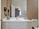 Stylish bathroom with white vanity, quartz countertop, and unique vertical slat wall design at 4441 Ganesha Loop, Kissimmee, FL 34746