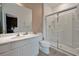 Contemporary bathroom featuring a walk-in shower, white vanity, and neutral wall and floor tiling at 4441 Ganesha Loop, Kissimmee, FL 34746