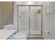 Modern bathroom featuring a glass enclosed shower, contemporary fixtures, and white stone countertops at 4441 Ganesha Loop, Kissimmee, FL 34746