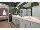 Spacious bathroom featuring a double vanity with white cabinets and a large mirror with excellent lighting at 4441 Ganesha Loop, Kissimmee, FL 34746