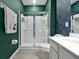 Bathroom featuring a glass shower, white cabinets, and decorative towels creating a clean and inviting space at 4441 Ganesha Loop, Kissimmee, FL 34746