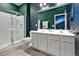 Bathroom with a double sink vanity, a sleek glass-enclosed shower, and decorative accents for an elegant design at 4441 Ganesha Loop, Kissimmee, FL 34746