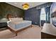 Elegant bedroom showcasing a stylish chandelier, dark wallpaper, and a cozy king-sized bed at 4441 Ganesha Loop, Kissimmee, FL 34746