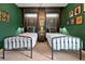 A well-lit bedroom showcasing two twin beds, dark wood accents, and decorative Hogwarts-themed wall decor at 4441 Ganesha Loop, Kissimmee, FL 34746
