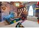 Themed bedroom with race car bed, car-themed wall decor, and ceiling light fixture at 4441 Ganesha Loop, Kissimmee, FL 34746