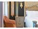 Bedroom with a stylish bedside table, unique chandelier, and elegant decor at 4441 Ganesha Loop, Kissimmee, FL 34746