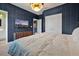Comfortable bedroom with a plush bed, modern lighting, and an open doorway to the en suite bathroom at 4441 Ganesha Loop, Kissimmee, FL 34746