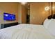 Bedroom with soft lighting, large tv, and a luxurious duvet at 4441 Ganesha Loop, Kissimmee, FL 34746