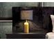 Close-up of a bedside table in a bedroom featuring a designer lamp and dark wood furniture at 4441 Ganesha Loop, Kissimmee, FL 34746