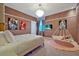 Charming bedroom featuring a unique hanging swing chair, colorful accents, and plush carpeting at 4441 Ganesha Loop, Kissimmee, FL 34746