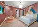 Whimsical bedroom design with hanging swing chair, unique lighting fixture, and plush carpeting at 4441 Ganesha Loop, Kissimmee, FL 34746