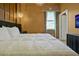 A cozy bedroom with a modern chandelier and a comfy looking white duvet at 4441 Ganesha Loop, Kissimmee, FL 34746