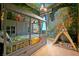 A whimsical bedroom with an imaginative mural, custom bed frame, and a play tent at 4441 Ganesha Loop, Kissimmee, FL 34746