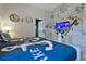 Nautical-themed bedroom featuring twin beds, brick wall décor, and a flat screen tv at 4441 Ganesha Loop, Kissimmee, FL 34746