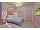 Enchanting bedroom featuring a castle theme, custom mural, chandelier, and unique decor at 4441 Ganesha Loop, Kissimmee, FL 34746