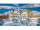 A community pool area with tables, chairs, palm trees, a splash pad and other water play equipment at 4441 Ganesha Loop, Kissimmee, FL 34746