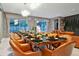 Formal dining room with large windows, a decorative chandelier, and seating for 12 at 4441 Ganesha Loop, Kissimmee, FL 34746