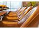 Close up of the side of the brown leather chairs in the dining room at 4441 Ganesha Loop, Kissimmee, FL 34746